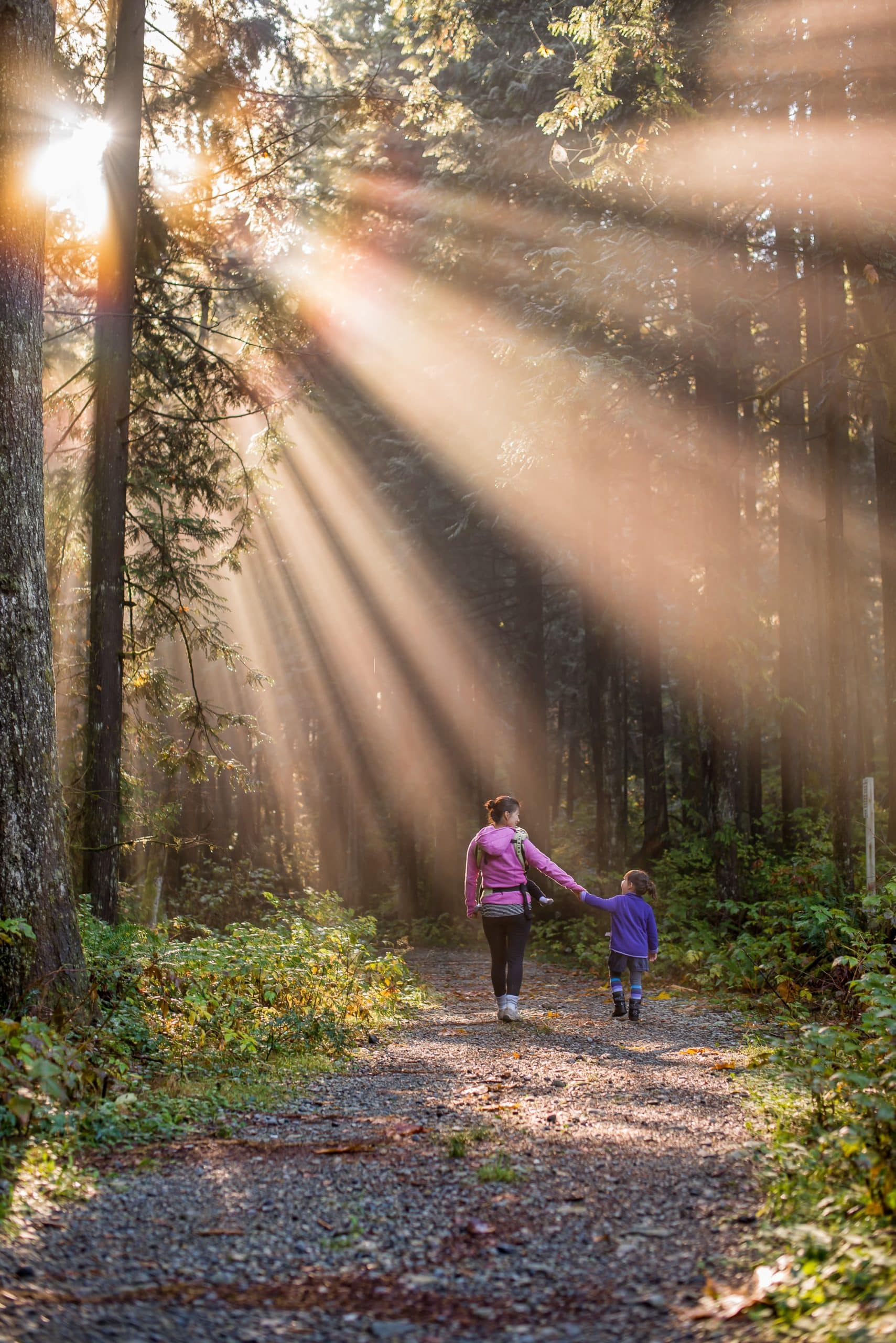 Mother and child walking down a nature path